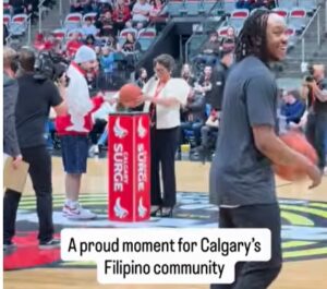 Philippine Consul General Emma Sarne presents the game ball.